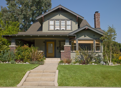 A brick house with a large front yard.